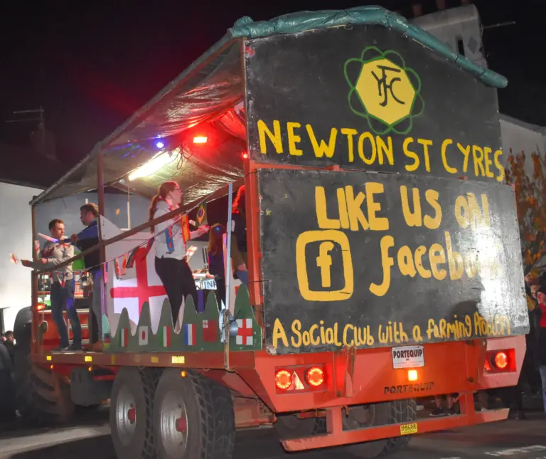 Newton St Cyres Young Farmers float on a trailer with a Like Us On Facebook board