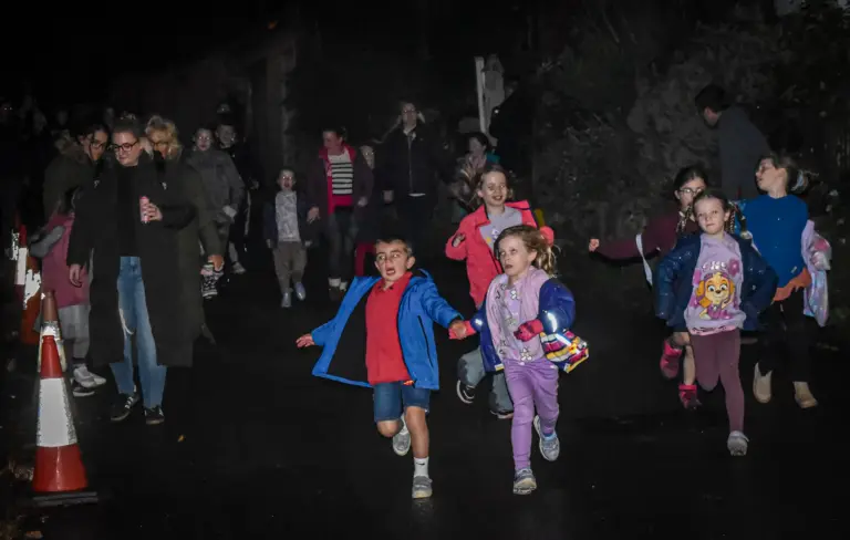Children running down the street on Friday evening of carnival weekend