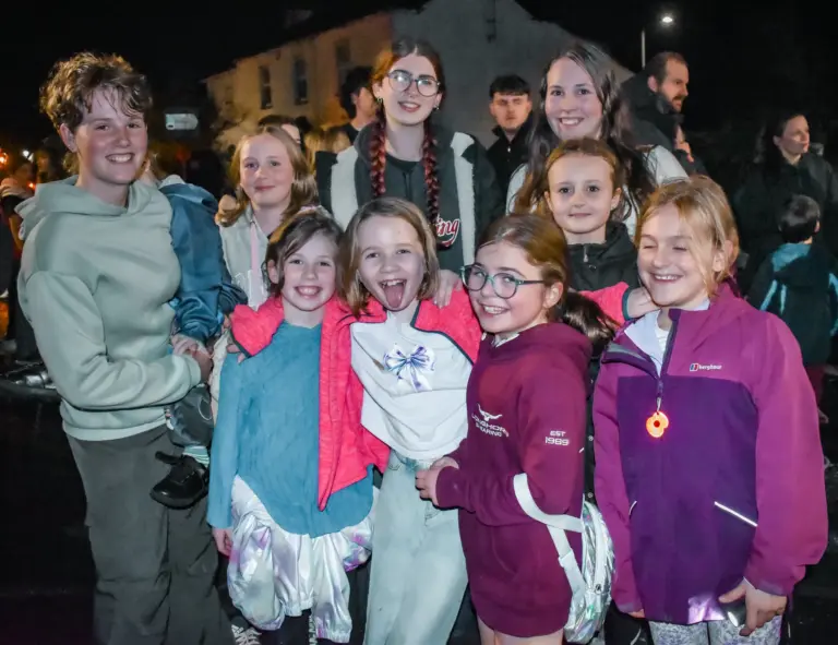 Group of smiling girls posing together on carnival Friday evening