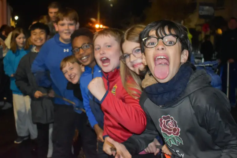 Group of boys pulling funny faces at the camera on carnival Friday night