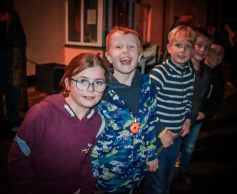 Group of children grinning at the camera on Friday evening