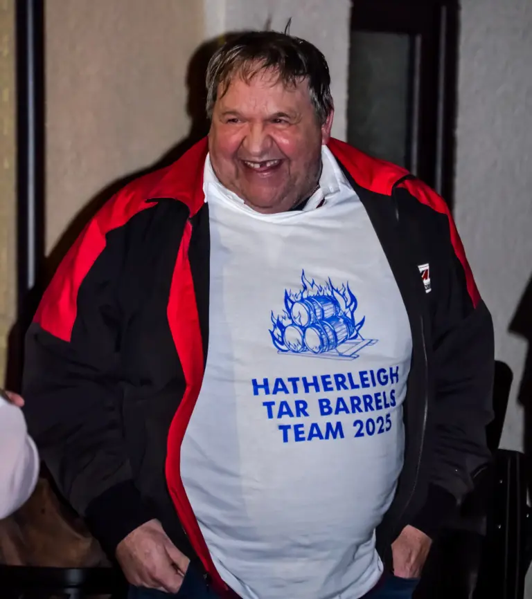 Laughing man wearing a Hatherleigh Tar Barrels Team 2025 T-shirt
