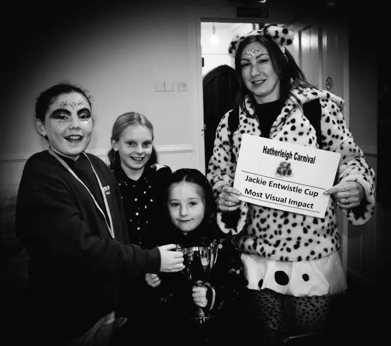 Black and white photo of the Dalmatian group holding the Jackie Entwistle Cup for Most Visual Impact