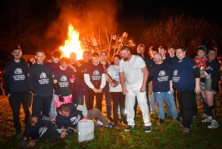Tar Barrels Team 2025 posing as a group in front of the blazing bonfire