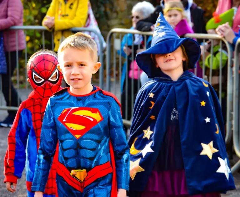 Children dressed as Spider-Man, Superman and a star-covered wizard at the fancy dress parade