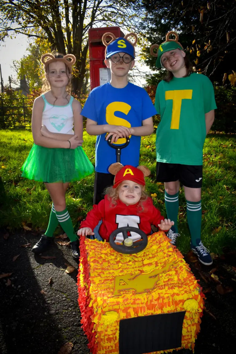 Children dressed as the Chipmunks with a little one in a pushchair float