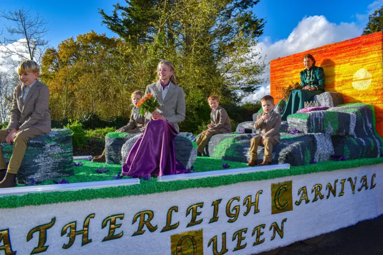 The Hatherleigh Carnival Queen float with the queen and her attendants seated on crepe-paper moorland