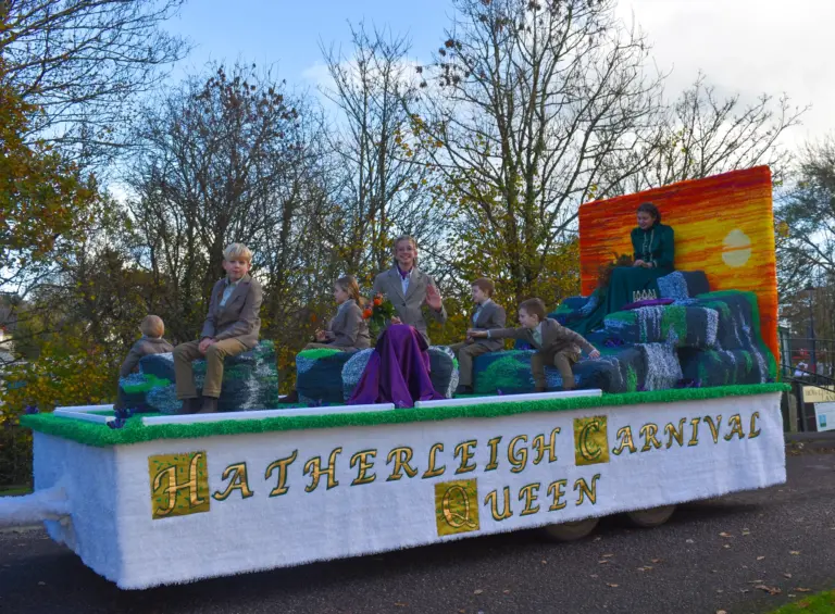 The Hatherleigh Carnival Queen float travelling along the street in autumn sunshine