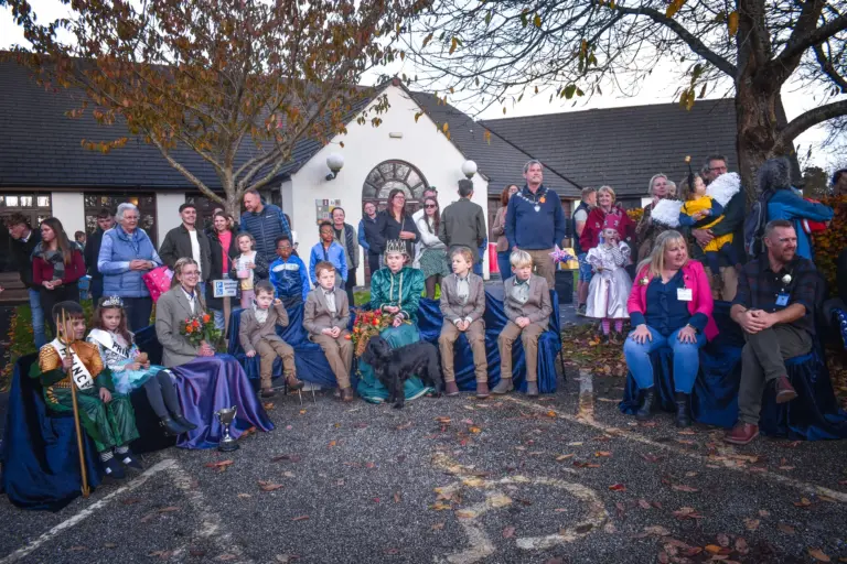 Carnival royalty, attendants and officials gathered outside the hall