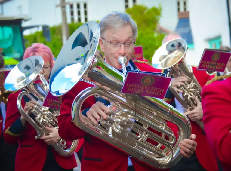 Hatherleigh Silver Band members playing tubas and euphoniums in the afternoon procession