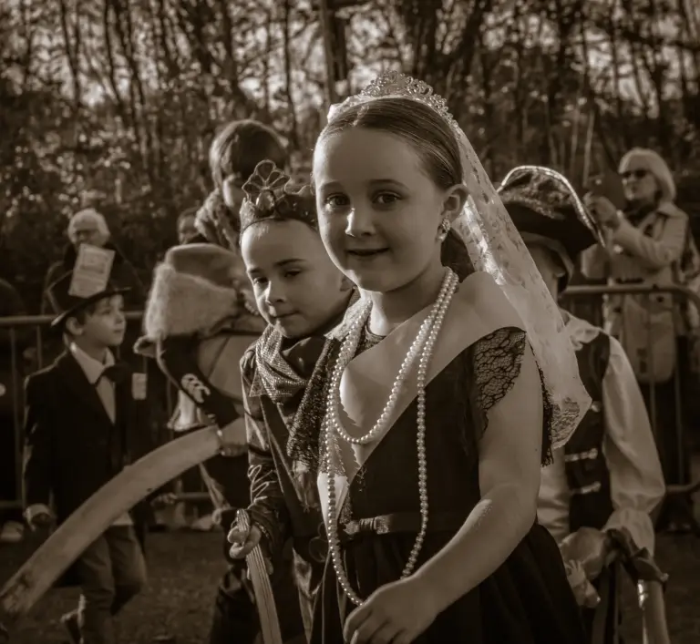 Sepia toned portrait of a young attendant in a tiara and lace veil