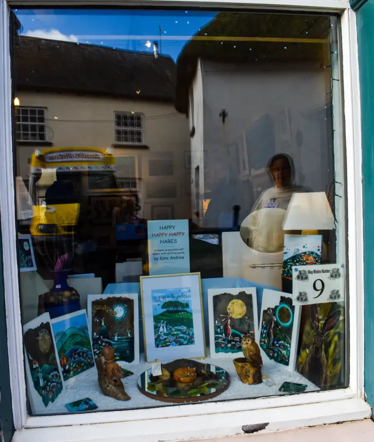 Shop window display of paintings and pottery for the window competition