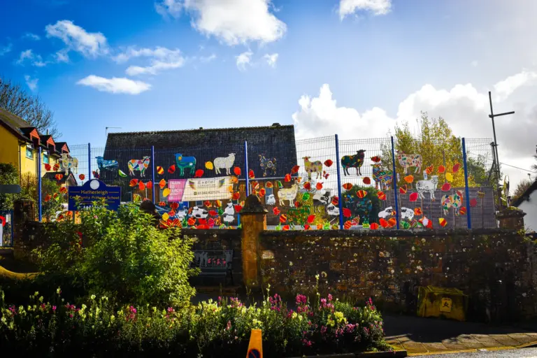 Hatherleigh Community Primary School fence decorated with painted animals and leaves