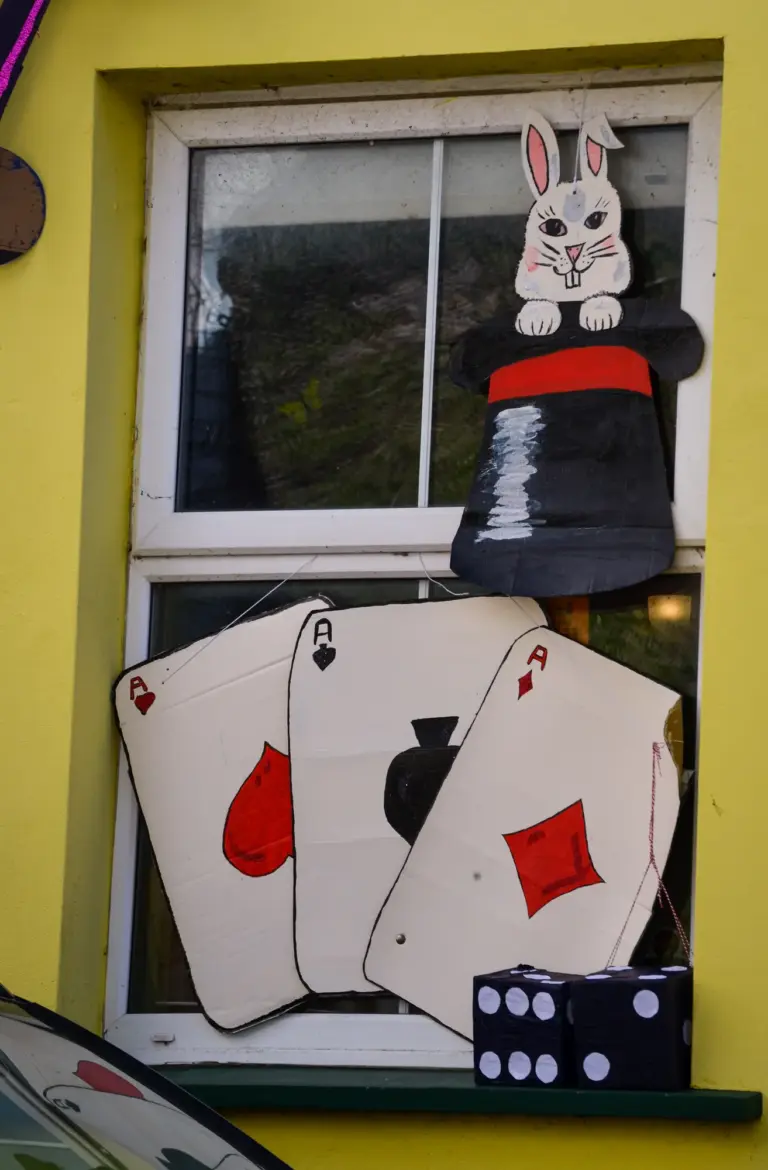 Window decorated with a rabbit in a top hat, giant playing cards and dice