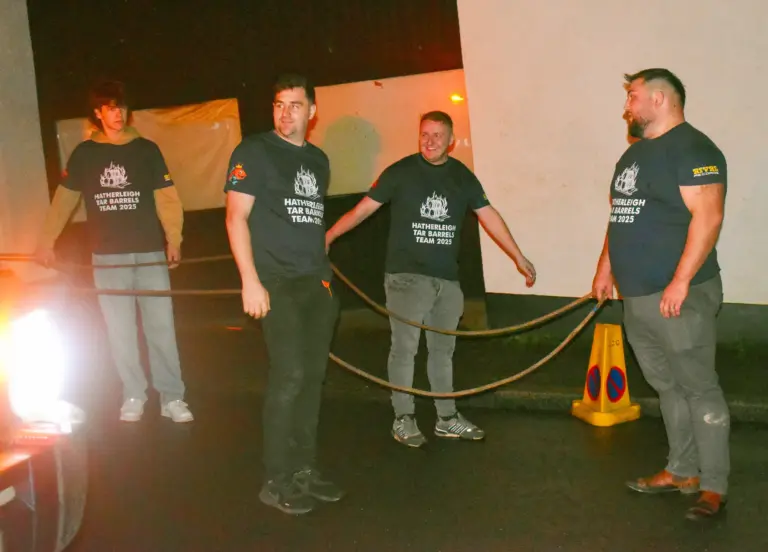 Tar Barrels Team 2025 members holding ropes ready to pull the burning barrels