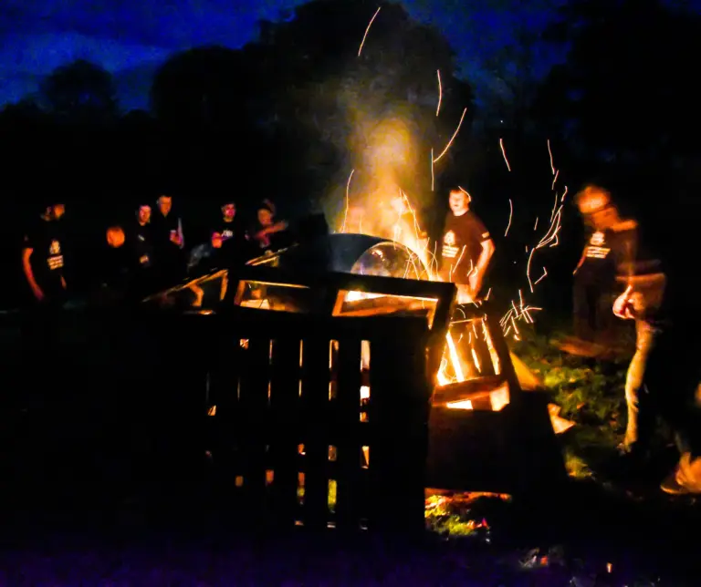 Wooden pallets and barrels catching fire as sparks fly at the bonfire