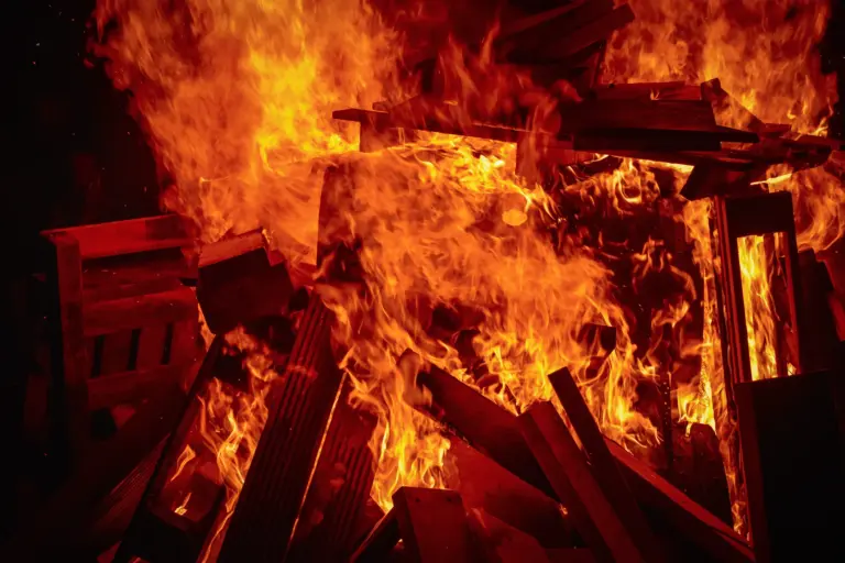 Close-up of the pallet bonfire engulfed in roaring orange flames