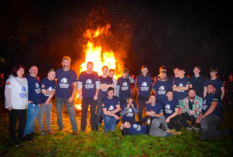 Tar Barrels Team 2025 group photo in front of the roaring bonfire
